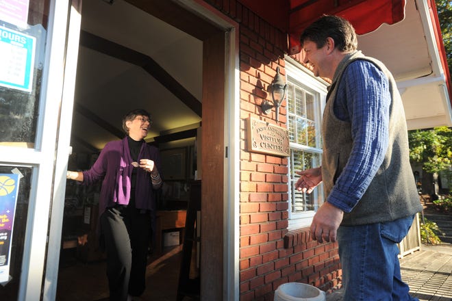 Black Mountain Swannanoa Chamber of Commerce Executive Director Sharon Tabor greets board president Jon Brooks at the door of the Andy Andrews Visitor Center.