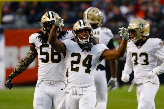 New Orleans Saints strong safety Vonn Bell (24) celebrates a sack with outside linebacker Demario Davis (56) during the second half of an NFL football game against the Chicago Bears in Chicago, Sunday, Oct. 20, 2019. (AP Photo/Charles Rex Arbogast)