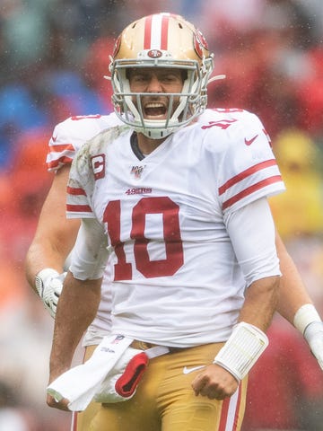 San Francisco 49ers quarterback Jimmy Garoppolo (10) reacts after running for a first down during the first quarter against the Washington Redskins at FedExField.