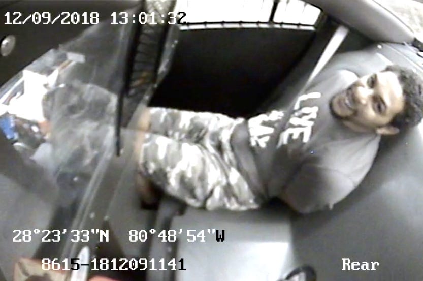 A still image from surveillance video show Gregory Lloyd Edwards as he is transported in the back of a police car. The 38-year-old veteran got into a confrontation with a deputy during his booking process on Dec. 9, 2018, and Edwards was beaten, kneed, sprayed with a chemical agent, shocked with a stun gun, handcuffed and strapped into a restraint chair with a spit hood covering his face. The decorated Army medic died the next day at a hospital.