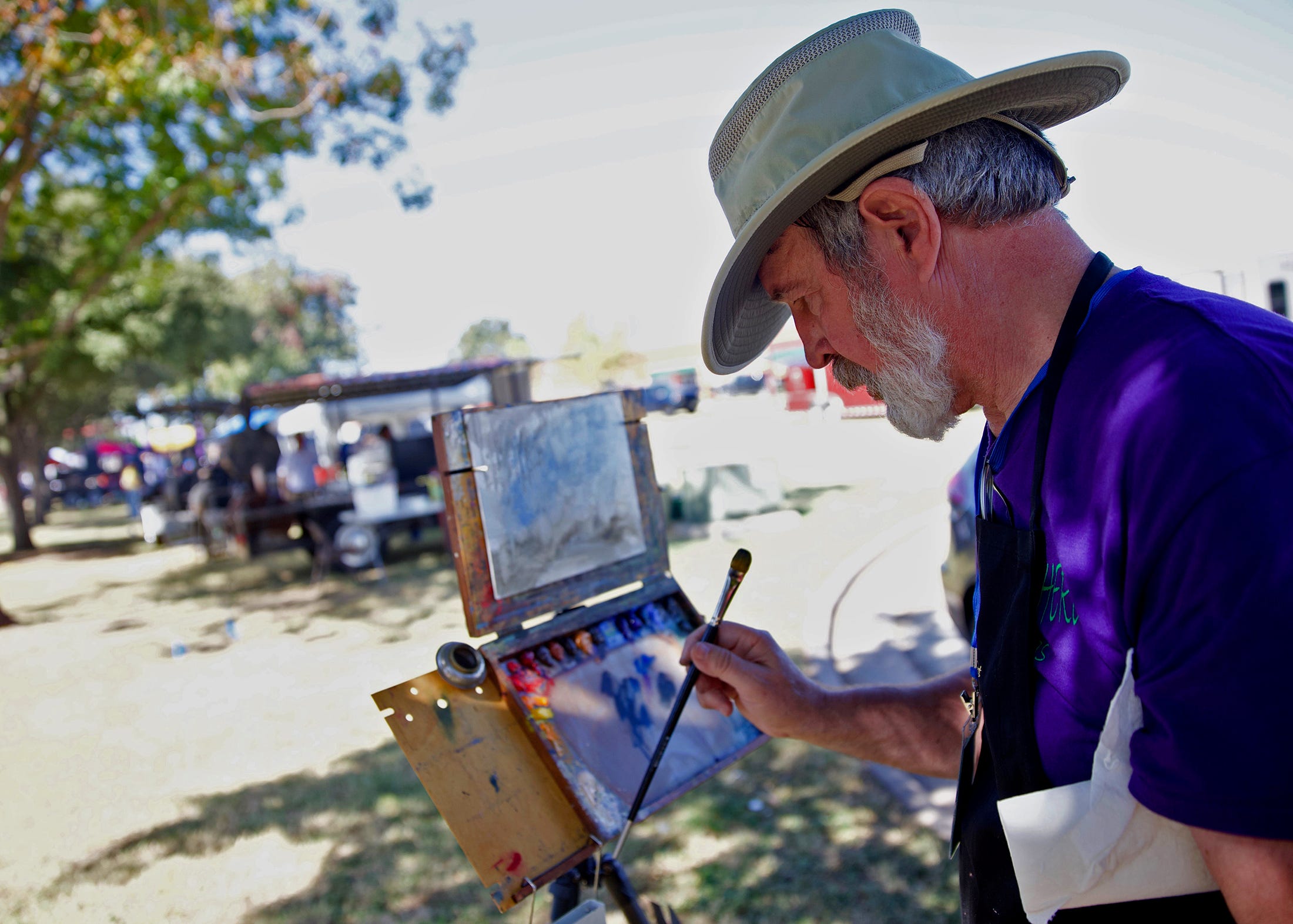 Bill Suys paints a picture outside during the Brews, Ewes and BBQ festival in San Angelo on Saturday, Oct. 19, 2019.