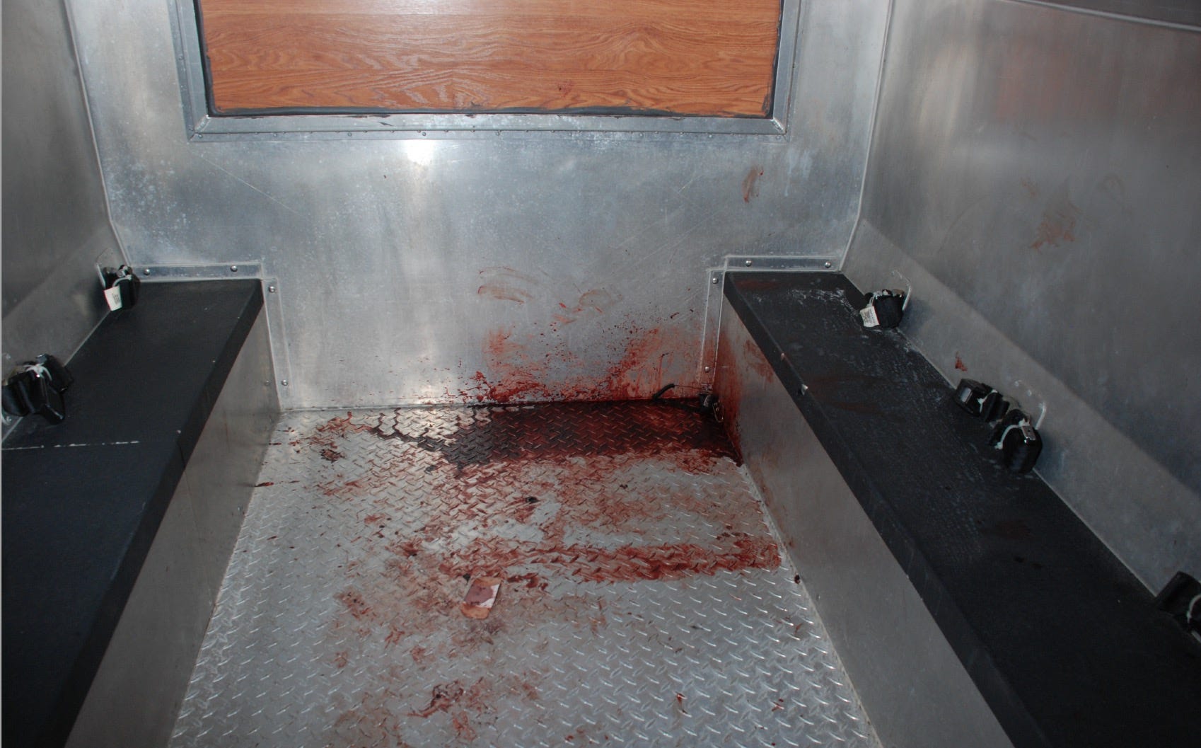 Blood is seen in the back of a transport van.