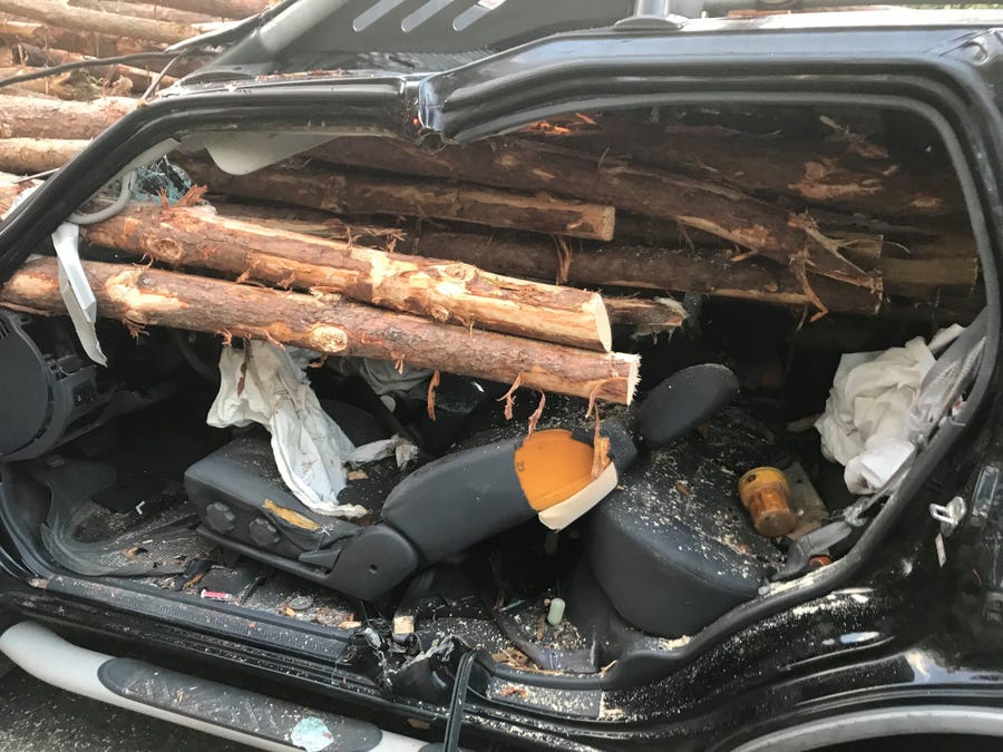 A Georgia driver was rescued alive after logs from a truck smashed through his windshield.