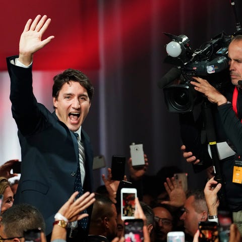 Canada Prime Minister Justin Trudeau waves as he g