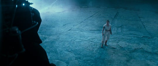 Rey (Daisy Ridley) is confronted by a dark figure – who looks a little like Emperor Palpatine – in 