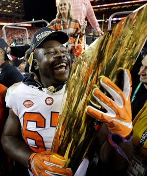 Eagles defensive tackle Albert Huggins celebrates after winning the National Championship with Clemson in January. The Eagles signed Huggins off the Houston Texans practice squad on Monday.