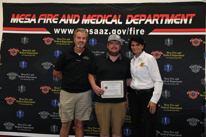 From left, Terry McCuin, Bradley McCuin and Mesa Fire Chief Mary Cameli.