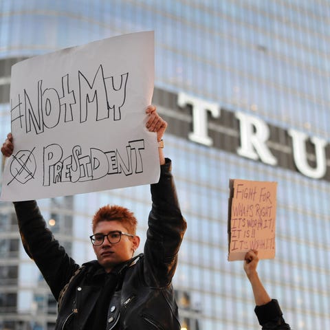 People take part in a protest near the Trump tower