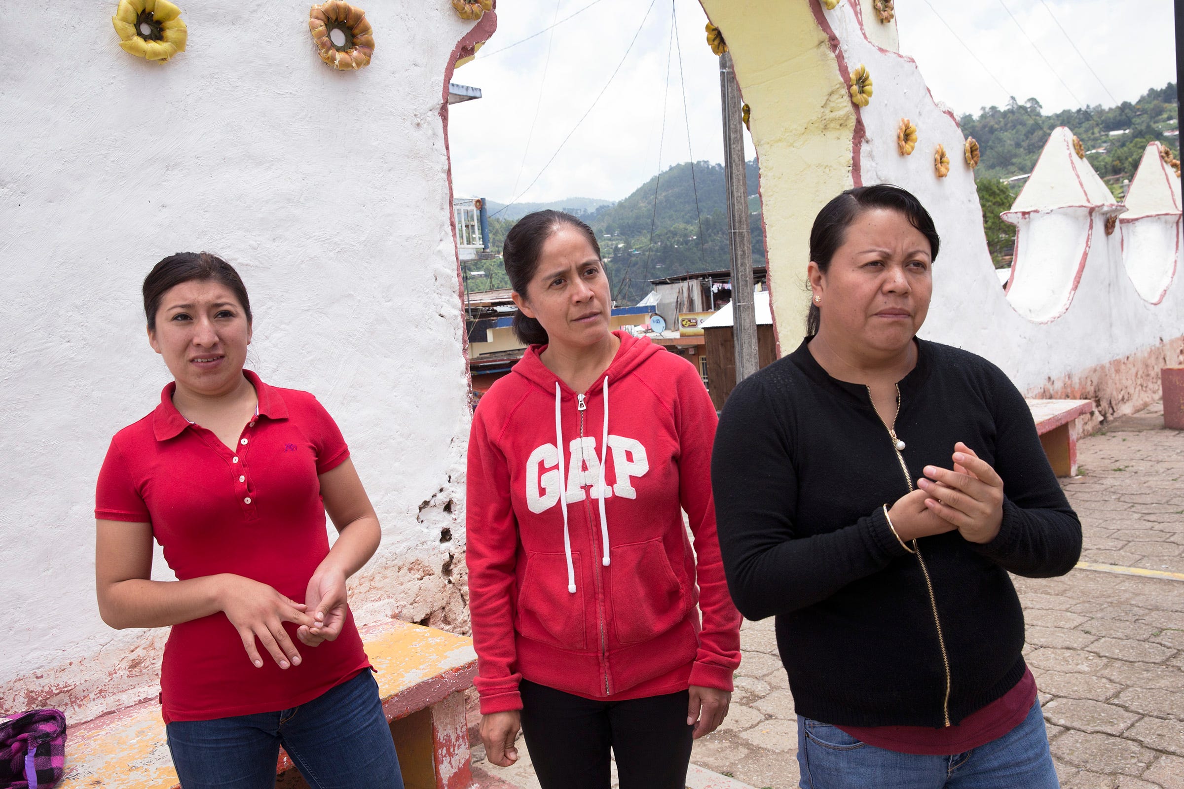 Blanca Hernández, center, walks with friends Lucero Quechulpa, left, and Fátima Anastasio in Texhuacán. The three worked at dairy farms in Wisconsin or Minnesota before returning to México.