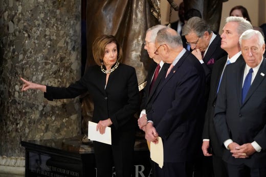 Speaker of the House Nancy Pelosi speaks to Senate Majority Leader Mitch McConnell and Senate Minority Leader Chuck Schumer at memorial services for Rep. Elijah Cummings in Statuary Hall at the U.S. Capitol in Washington, Oct. 24, 2019. Late Maryland Representative Elijah Cummings died on Oct. 17, 2019.&nbsp;