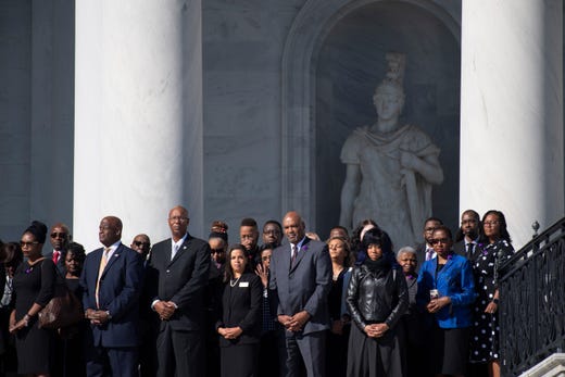 Family and friends of Rep. Elijah Cummings D-Md stand on the east front steps of the U.S. Capitol as the honor guard carries his casket into the U.S. Capitol where Cummings will lie in state at a ceremony in Statuary Hall in the U.S. Capitol.&nbsp;