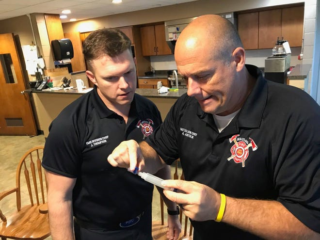Wausau EMS Division Chief Jared Thompson, left, and Battalion Chief Al Antolik train with the Handtevy app.