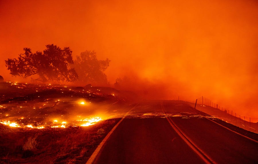 Embers blow across a road during the Kincade fire near Geyserville, Calif. on Oct. 24, 2019.