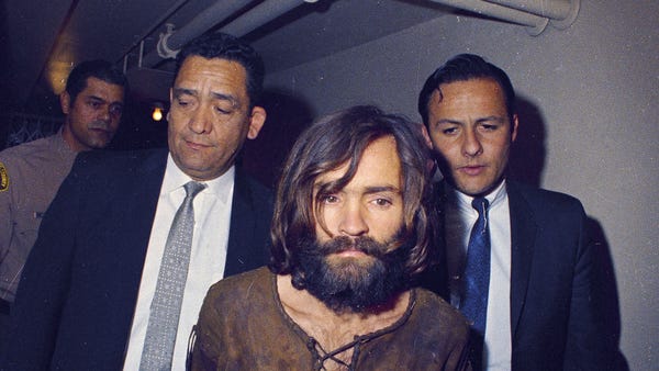 Charles Manson is escorted to his arraignment on c
