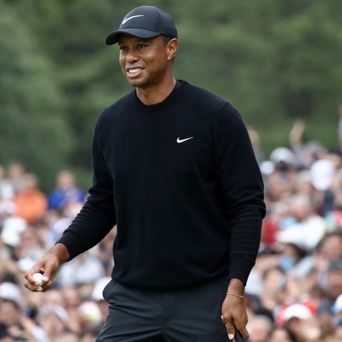 Tiger Woods reacts after holing out on the ninth g