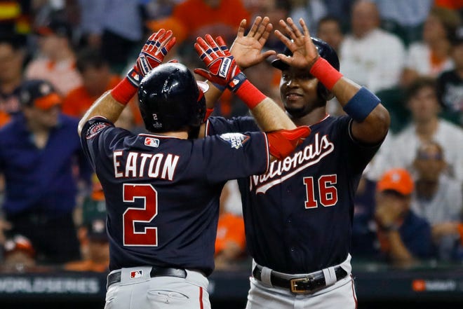 Washington Nationals' Adam Eaton celebrates his two-run home run with Victor Robles in the eighth inning.