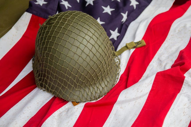 Soldier's helmet and the times of the Second World War and the US flag. Patriotism