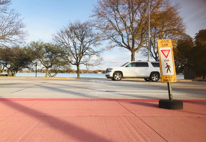 A car passes one of several crosswalks on Riverside Avenue Thursday, Oct. 24, 2019, in St. Clair. The crosswalks were repainted when the road diet restriping was done this summer. Some city officials had questions this week about jaywalking.