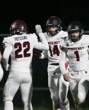 Pinckney receiver Caleb Wardlow (14) is congratulated by Sal Patierno after the first of his two touchdown catches in a 16-6 victory over Fowlerville on Friday, Oct. 25, 2019.