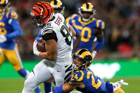 Cincinnati Bengals tight end Tyler Eifert (85) completes a catch as Los Angeles Rams safety Taylor Rapp (24) makes a tackle in the first quarter of a Week 8 NFL game, Sunday, Oct. 27, 2019, at Wembley Stadium in London, England. The Los Angeles Rams lead 17-10 at halftime. 