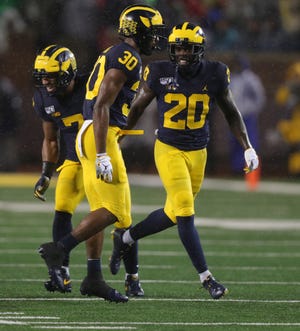 Michigan Wolverines defensive back Daxton Hill (30) celebrates his tackle against Notre Dame with Brad Hawkins (20) during the first quarter Saturday, Oct. 26, 2019 at Michigan Stadium in Ann Arbor.