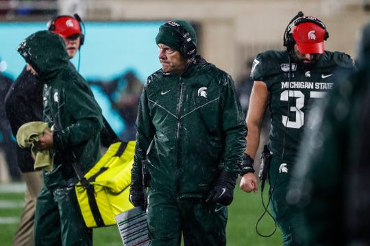 Michigan State coach Mark Dantonio walks off the field after speaking to players at a timeout during the second half against Penn State at Spartan Stadium in East Lansing, Saturday, Oct. 26, 2019.