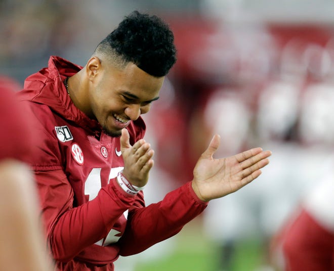 Oct 26, 2019; Tuscaloosa, AL, USA; Alabama Crimson Tide quarterback Tua Tagovailoa (13) reacts to his brother Alabama Crimson Tide quarterback Taulia Tagovailoa (5) going out to play during the second half against the Arkansas Razorbacks at Bryant-Denny Stadium. Mandatory Credit: Butch Dill-USA TODAY Sports