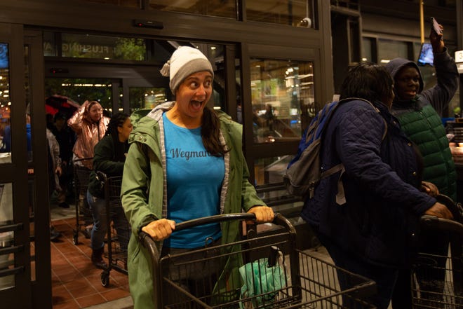 Nicole Sandretto, a self-proclaimed Wegmaniac, reacts to seeing the new Wegmans location in Brooklyn, New York. Sandretto waited for a few hours to be one of the first into the grocery store chain's Brooklyn, New York, location on Sunday, Oct. 27, 2019.