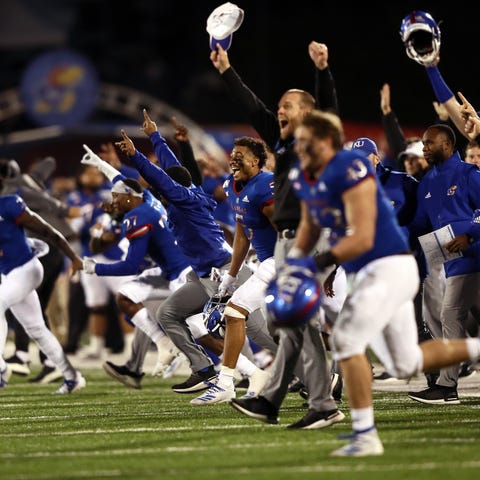 The Kansas Jayhawks storm the field after beating 