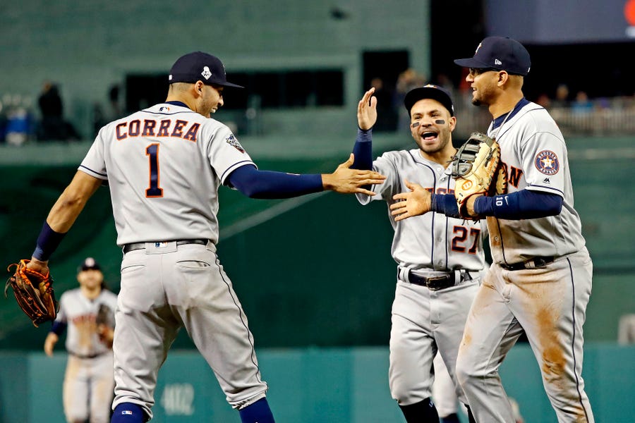 Astros infielders celebrate after Yuli Gurriel made a diving play to end a threat in the sixth.