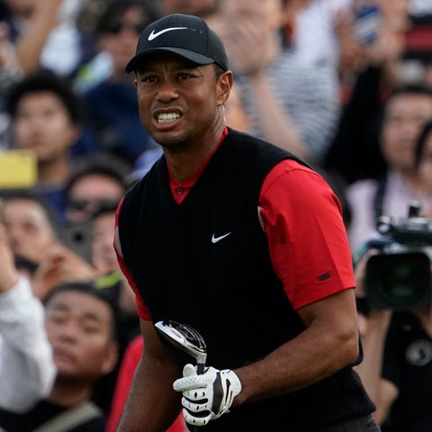 Tiger Woods watches his tee shot on the eighth hol