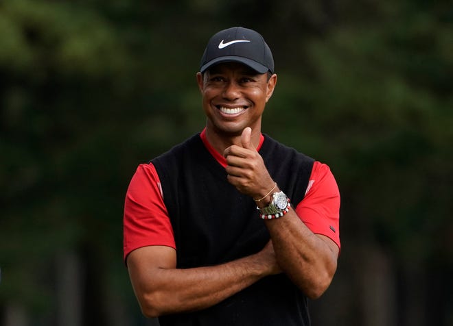 Tiger Woods gestures during the winner's ceremony after winning the Zozo Championship on Sunday.