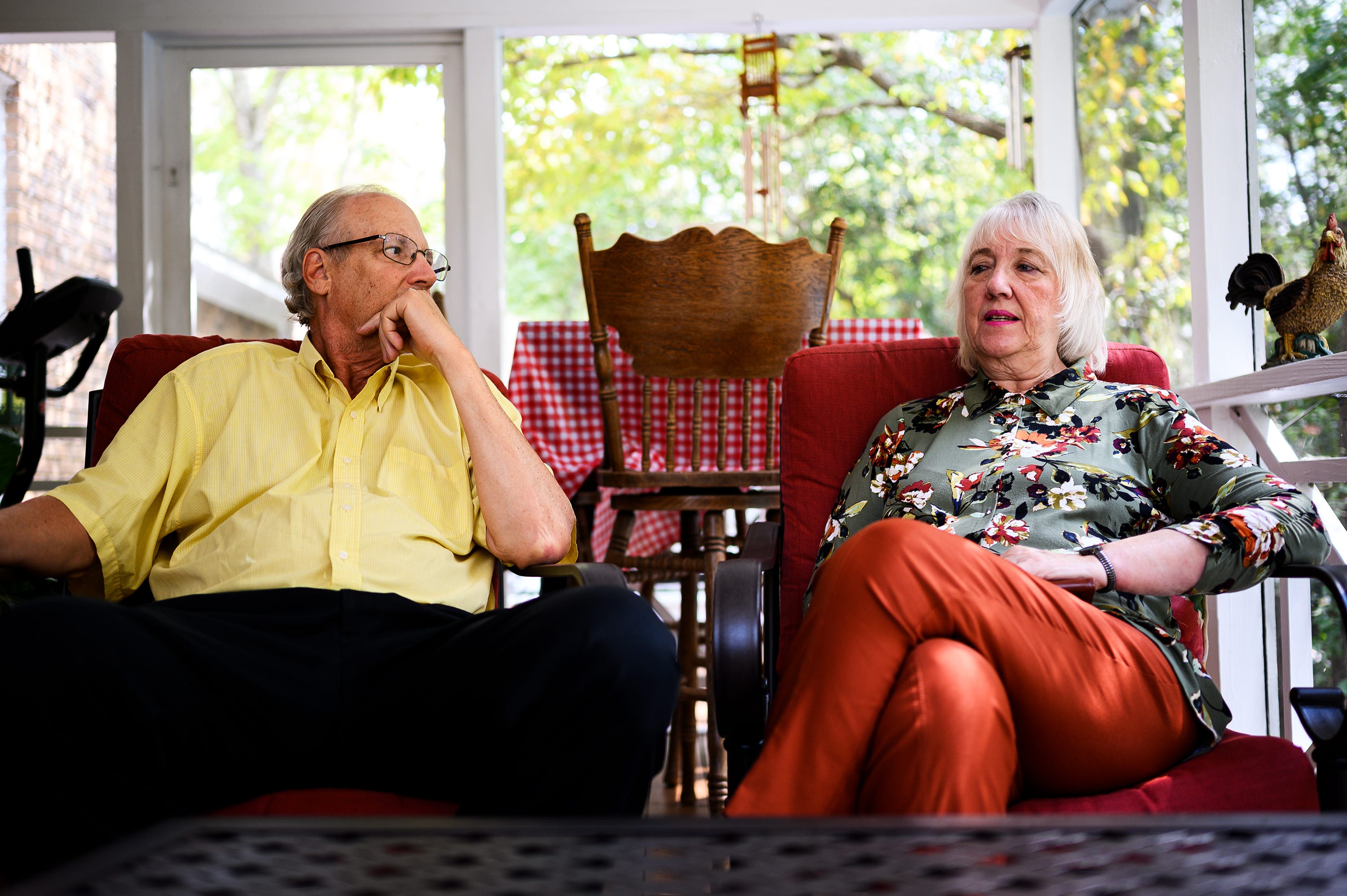 Dolores Stegelin sits with her husband, Forrest, in the sun room of their home in Columbia, South Carolina. They are each retired professors.