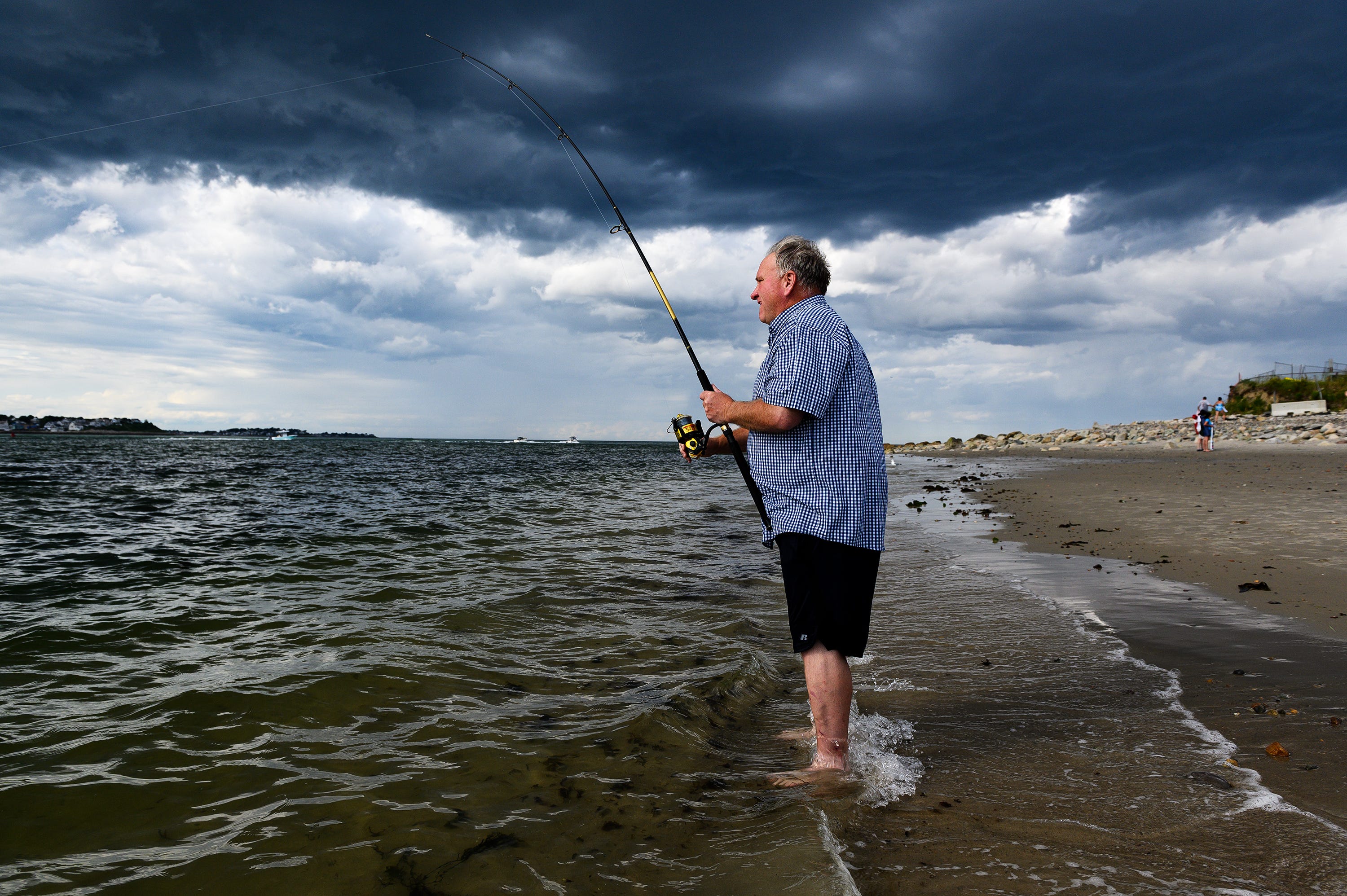 Dan Meehan casts his fishing line into the water on a windy afternoon at the Fourth Cliff Family Recreation Area in August. He says he finds peace in nature.