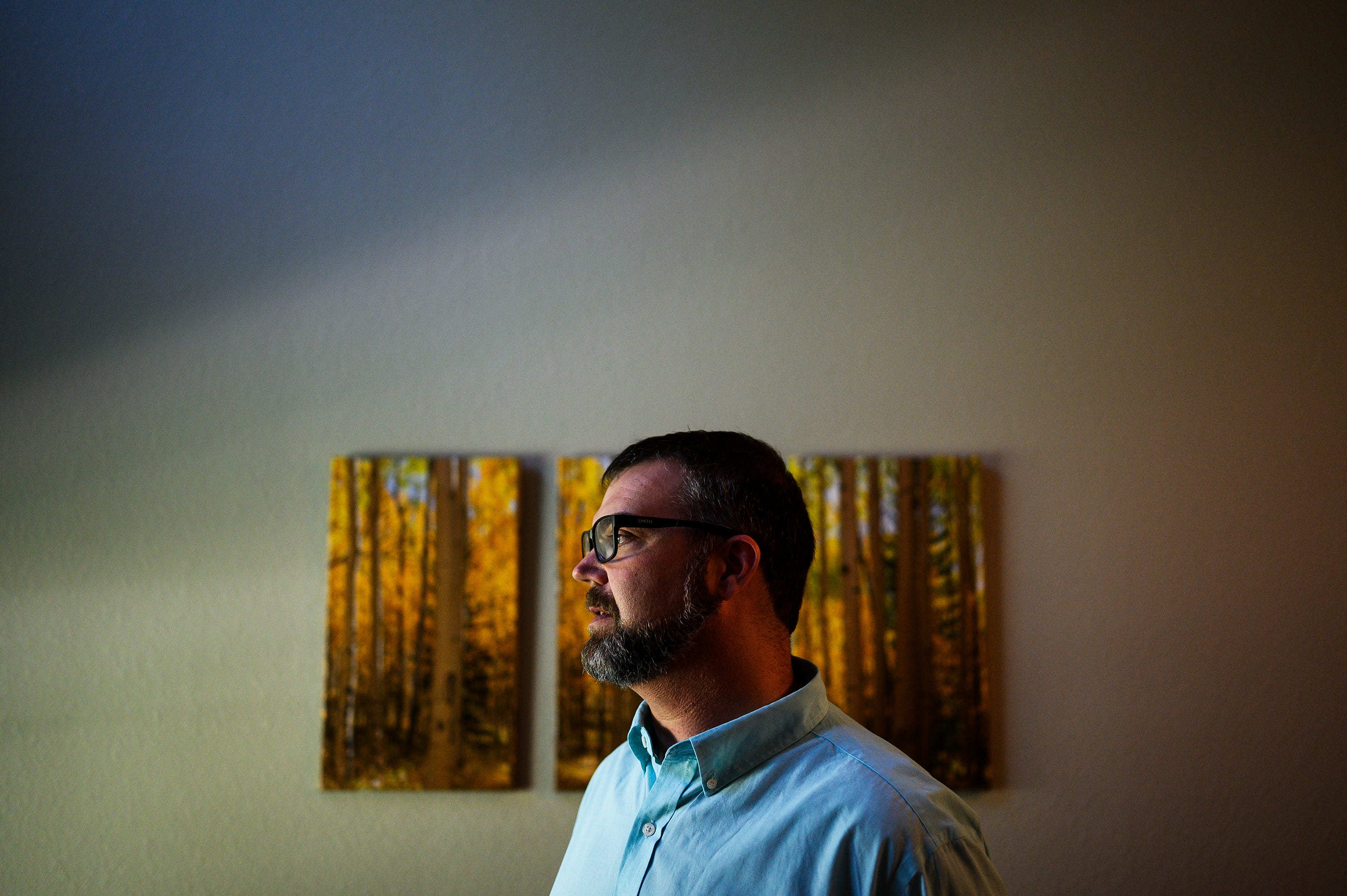 Michael Haring stands in his townhouse in Longmont, Colorado. He suffered financial hardships following his deployment in Iraq.