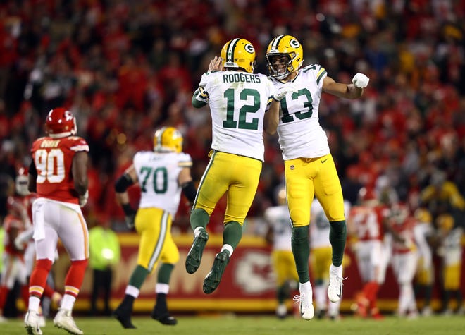 Quarterback Aaron Rodgers #12 and wide receiver Allen Lazard #13 of the Green Bay Packers celebrate after a touchdown during the game against the Kansas City Chiefs at Arrowhead Stadium on October 27, 2019 in Kansas City, Missouri.