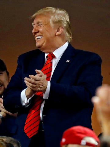 President Donald Trump acknowledges the crowd at Game 5 of the World Series.