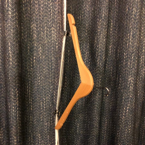 Use a skirt/trouser hanger to keep the curtains cl