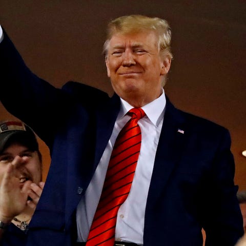 Trump waves to the crowd during Game 5.