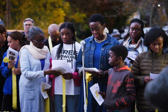 Opeyemi Sowore, (blue jacket), the wife of Nigerian journalist Omoyele Sowore, who is in a Nigerian prison where he has been held since August, reads a prayer together with her children as Haworth residents gather to demand his release, photographed in front of Borough Hall in Haworth on10/87/19. 