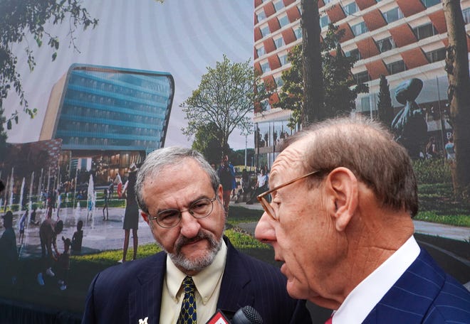 Mark Schlissel, left, president of the University of Michigan, and philanthropist Stephen Ross speak to the news media following a news conference on Wednesday, Oct. 30, 2019, for the announcement of the new $300 million U-M Detroit Center for Innovation on the 14-acre site of the abandoned Wayne County Jail project in Detroit.