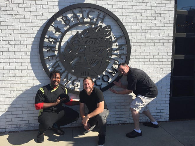 Yum Village chef and owner Godwin Ihentuge, left, and Stephen Roginson and Matt Johnson of Batch Brewing.