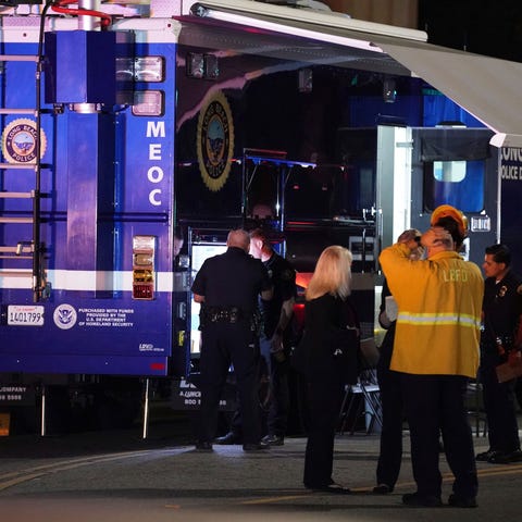 Police gather outside a mobile command post as the