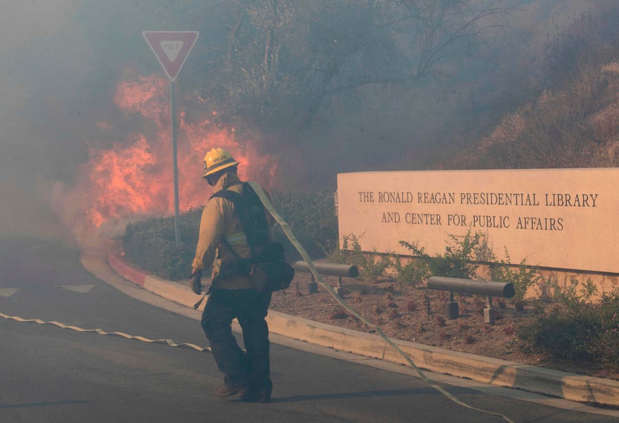 Firefighters battle to protect the Reagan Library from the Easy Fire in Simi Valley, California on October 30, 2019.