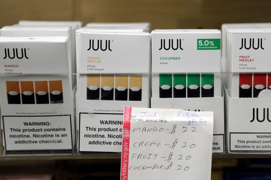 In this Thursday, Dec. 20, 2018 file photo, Juul products are displayed at a smoke shop in New York. On Thursday, Oct. 17, 2019, the company announced it will voluntarily stop selling its fruit and dessert-flavored vaping pods.