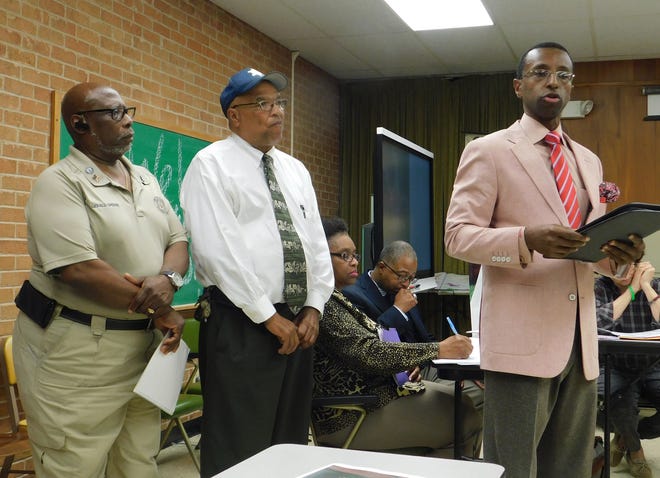 Opelousas City Marshal Paul Mouton (center) and Pastor Floyd Prescott III submit proposals earlier this week for the use of the former North Elementary School building. At left is Gerald Greene, coordinator for parish programs for St. Landry's elderly.