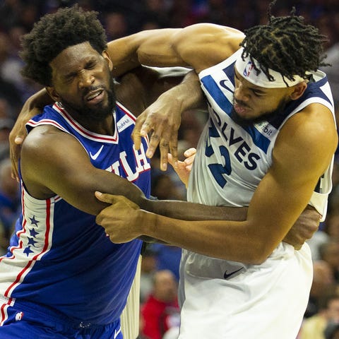 Joel Embiid, left, and Karl-Anthony Towns fight.