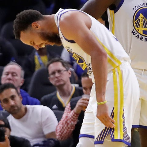 Steph Curry grimaces in pain after breaking his ha