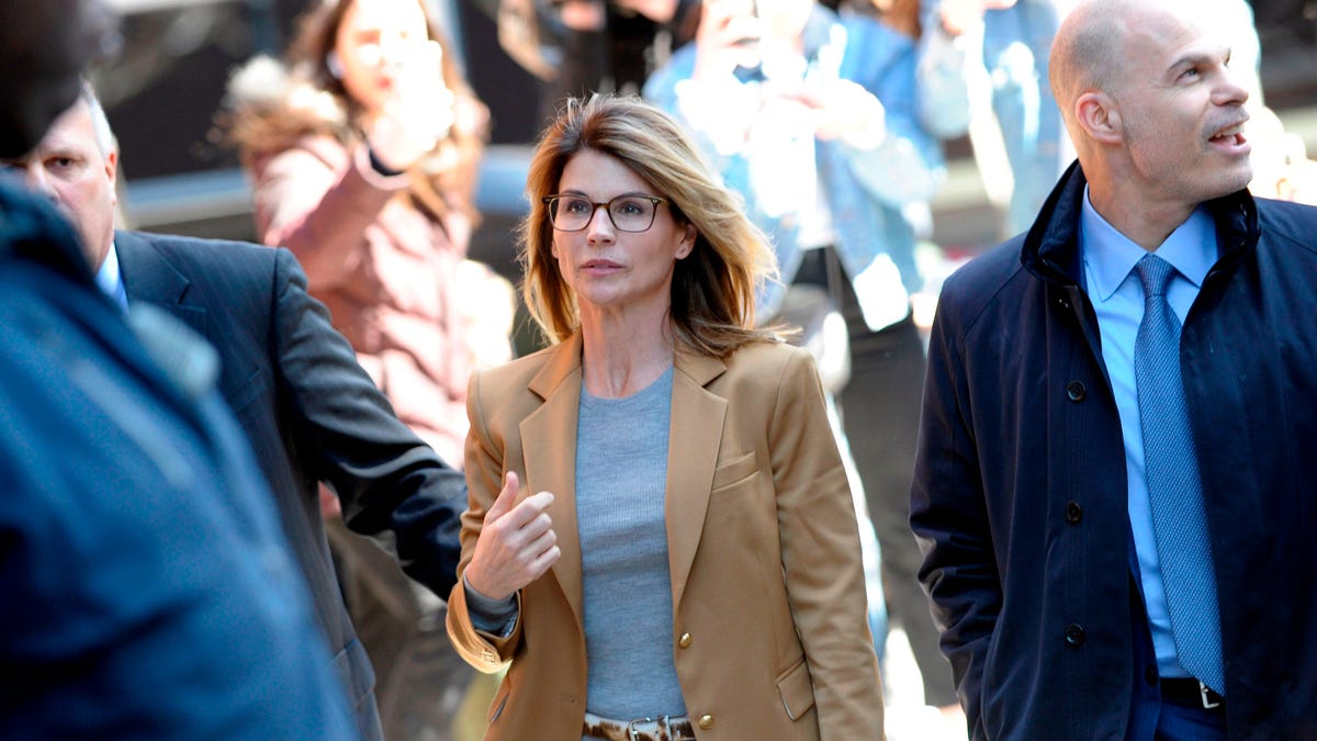 Actress Lori Loughlin (C) arrives at the court to appear before Judge M. Page Kelley to face charge for allegedly conspiring to commit mail fraud and other charges in the college admissions scandal at the John Joseph Moakley United States Courthouse in Boston, Massachusetts on April 3, 2019. (Photo by Joseph Prezioso / AFP)JOSEPH PREZIOSO/AFP/Getty Images ORIG FILE ID: AFP_1FC6UN