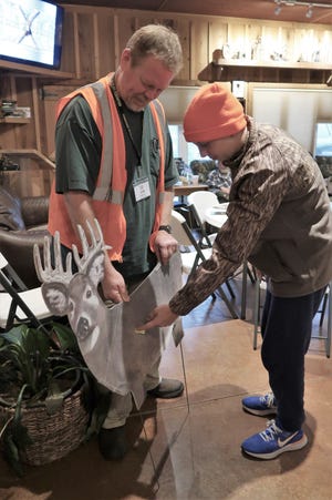Hunt master John Hopper shows Carson Huff the proper place to shoot a deer during a Tennessee Wildlife Foundation hunting academy workshop.